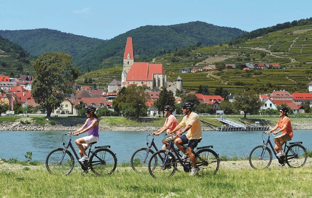 Golf Ahoy Danube River Golf Cruise AmaMagna four guests cycling on bank of danube river